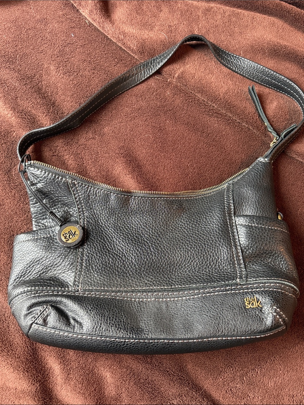 The Sak Black Pebbled Leather Shoulder Bag with Gold Accents